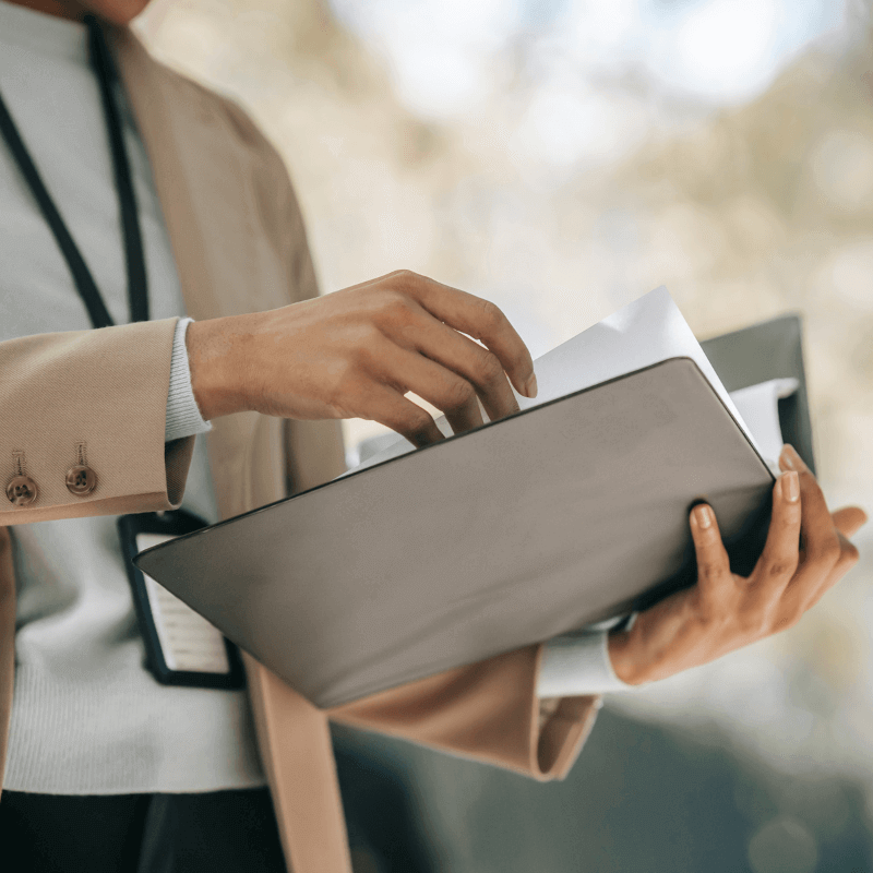 A picture of a VA mortgage lender holding a binder with documents.