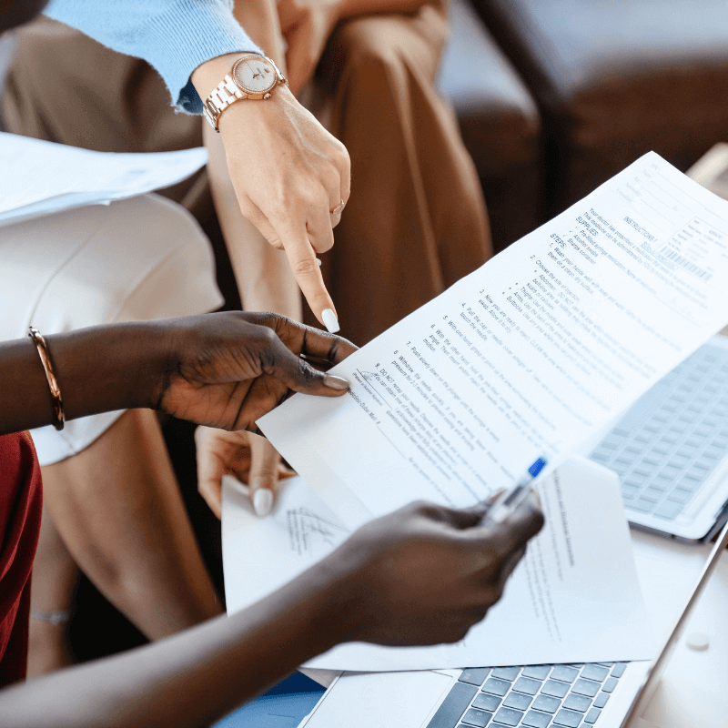 A picture of two people looking at a VA loan document together.